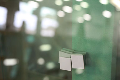 A photograph of a stack of car windows in the Auto Glass division of Jackson Glass works